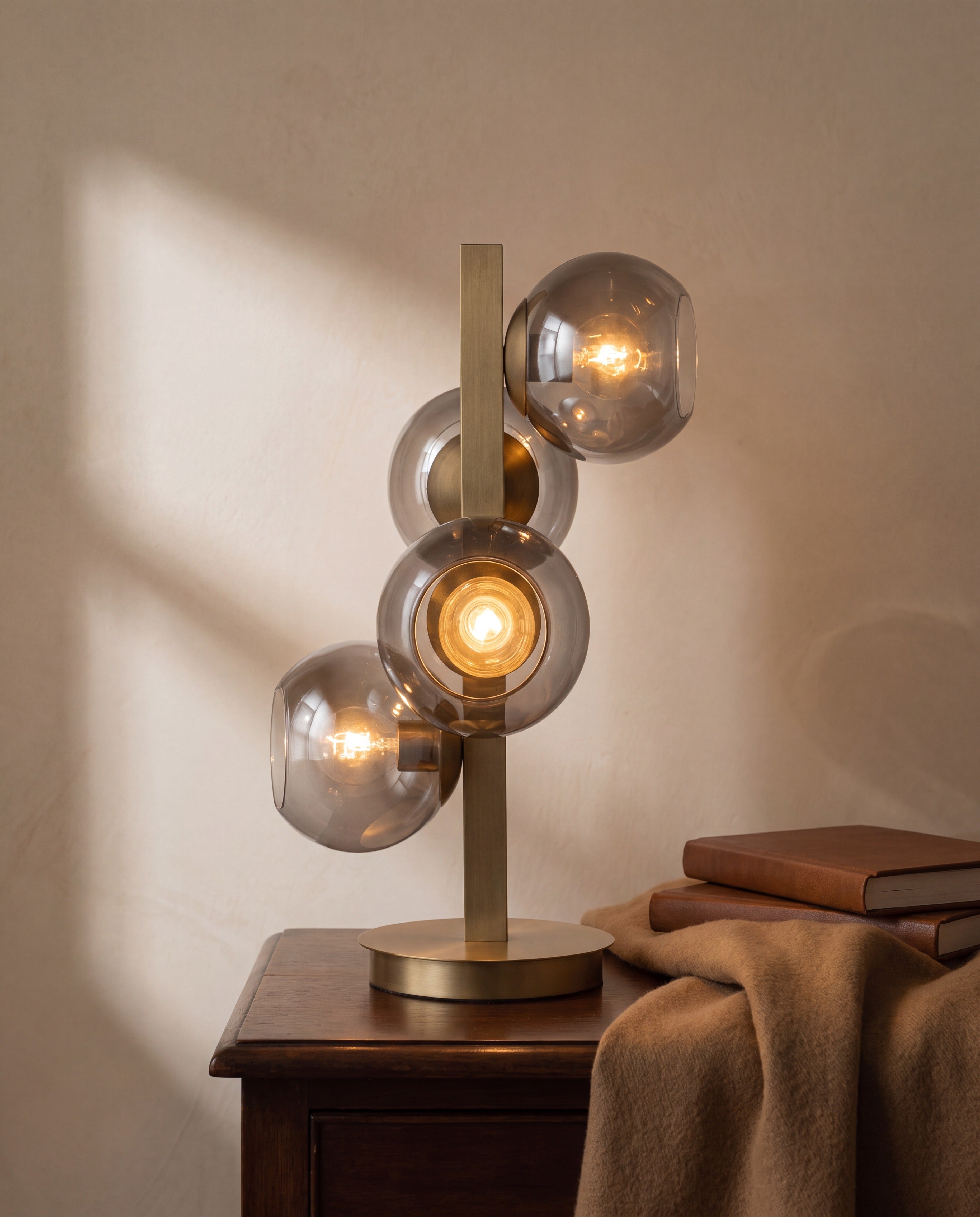 Brass Four-Light Table Lamp with Silver Globe Shades — illuminated, warm glow