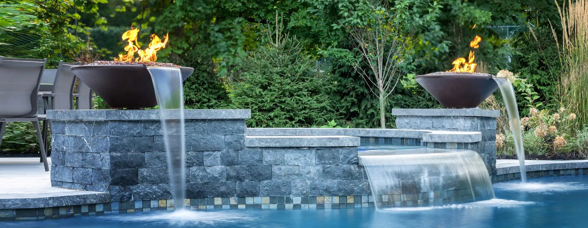 Concrete fire and water bowls spilling into a pool
