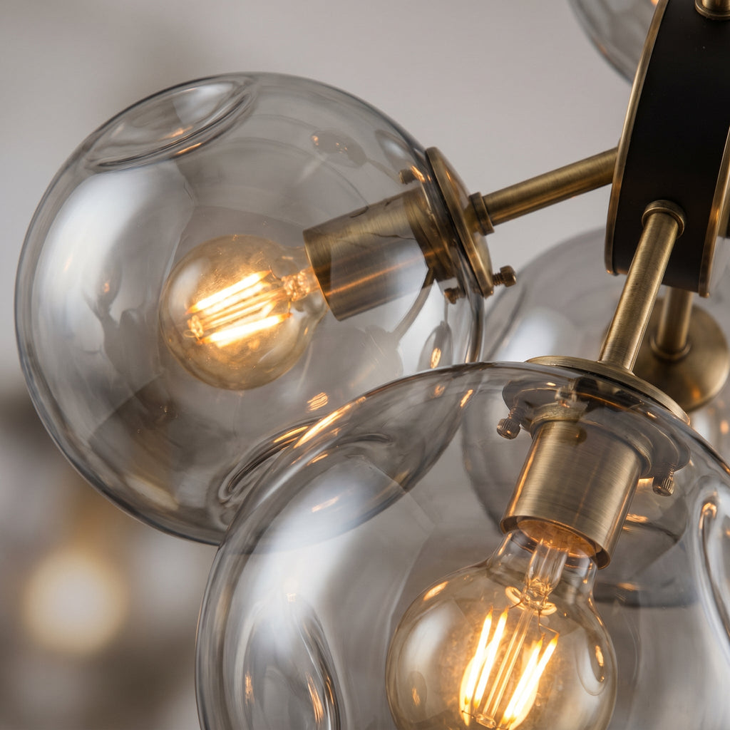 Close-up of two smoked glass globes showing semi-transparent glass and warm filament bulb glow