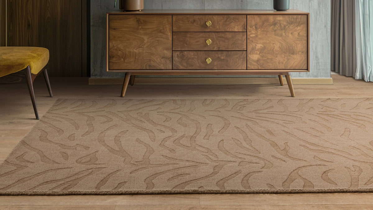 A patterned wool rug filling the floor beneath a walnut sideboard