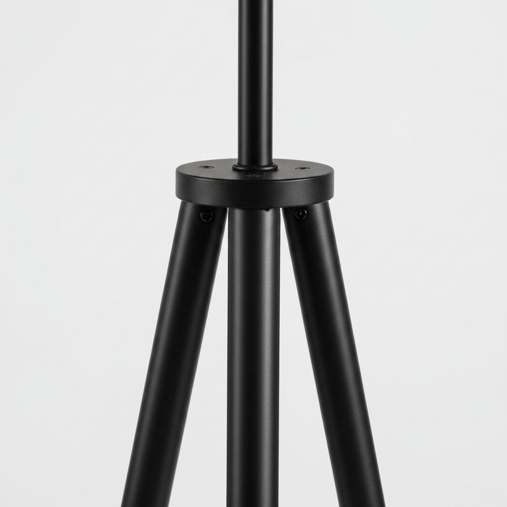 Close-up detail of black tripod floor lamp leg junction and hardware finish
