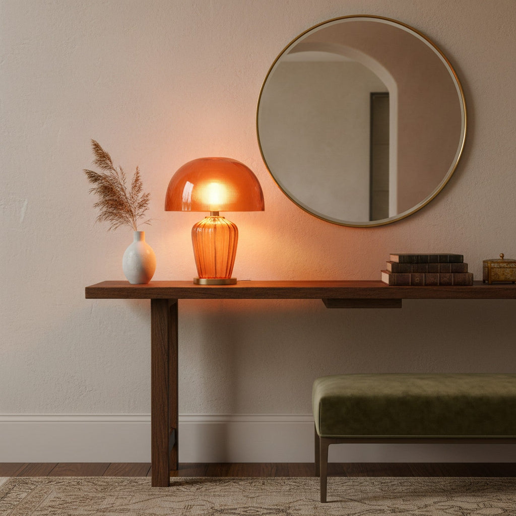 Murano amber glass table lamp on entryway console table with mirror and decorative objects