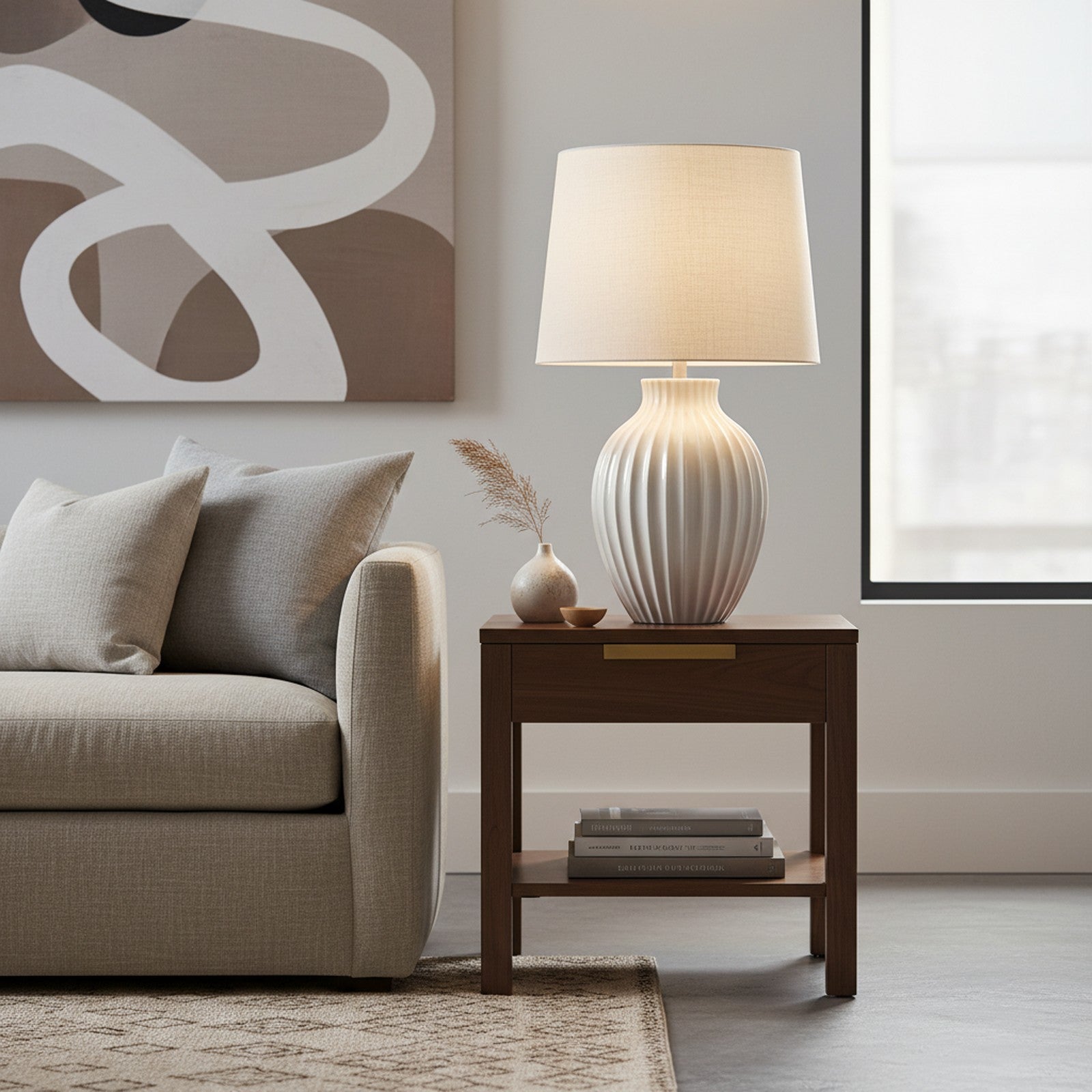 White ceramic textured table lamp on living room side table next to linen sofa