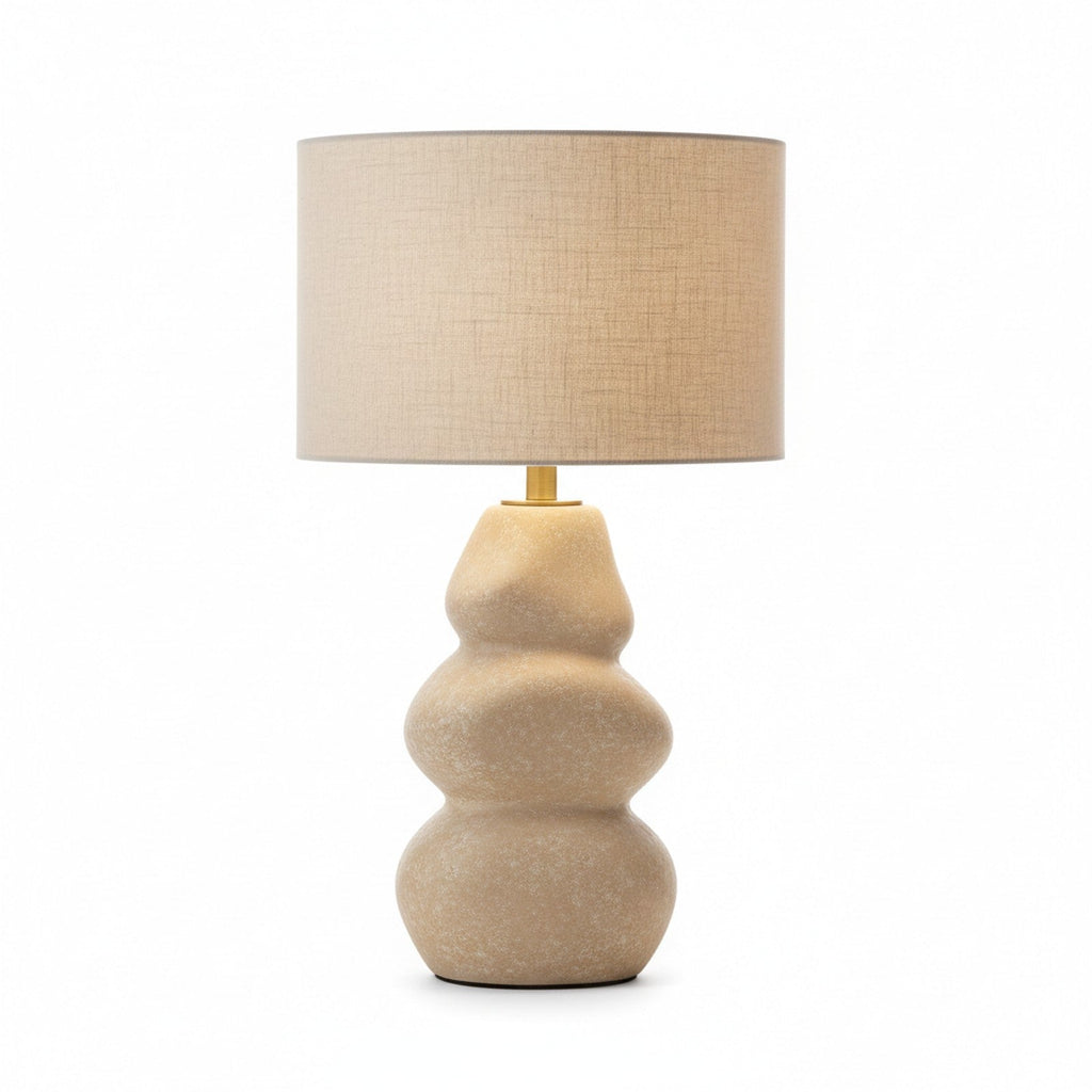 Cast stone sculptural table lamp in natural beige with organic river stone form and linen shade